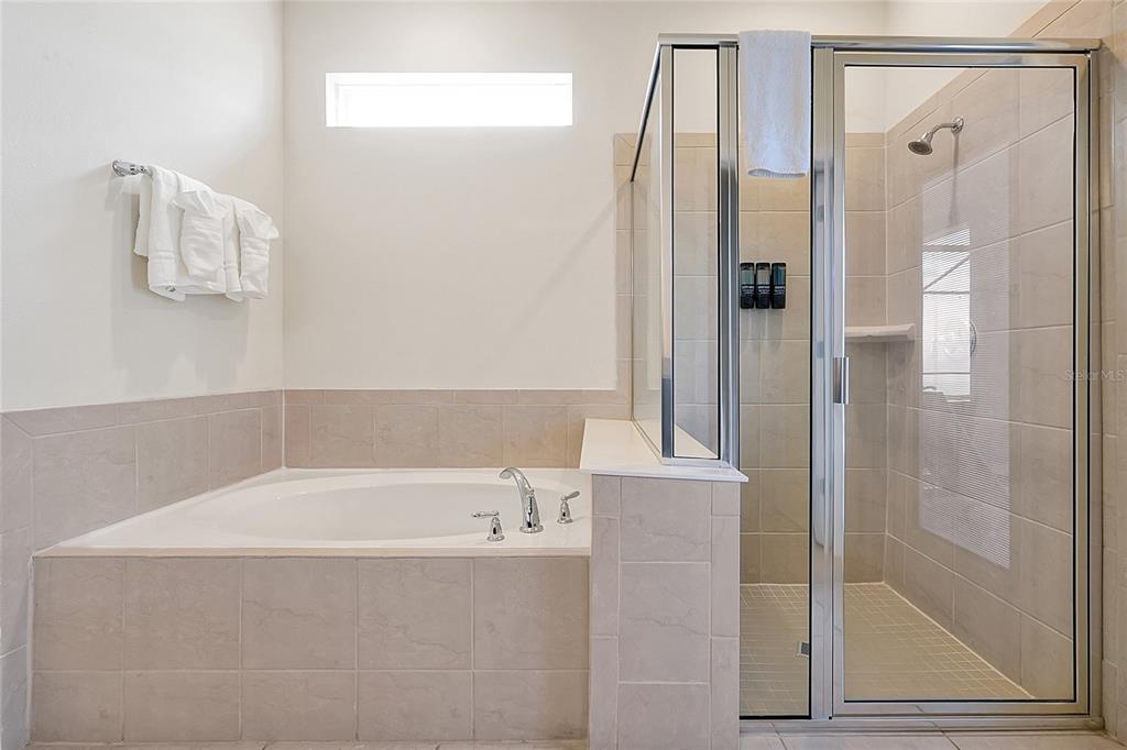 4494 Kaipo Road Davenport, FL 33897 - Photo 40 of 100 a bathroom with a bathtub and shower