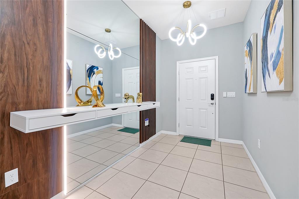 4494 Kaipo Road Davenport, FL 33897 - Photo 4 of 100 a bathroom with a sink a vanity and a mirror