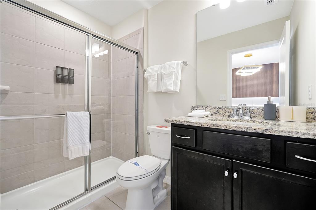 4494 Kaipo Road Davenport, FL 33897 - Photo 61 of 100 a bathroom with a sink toilet and shower