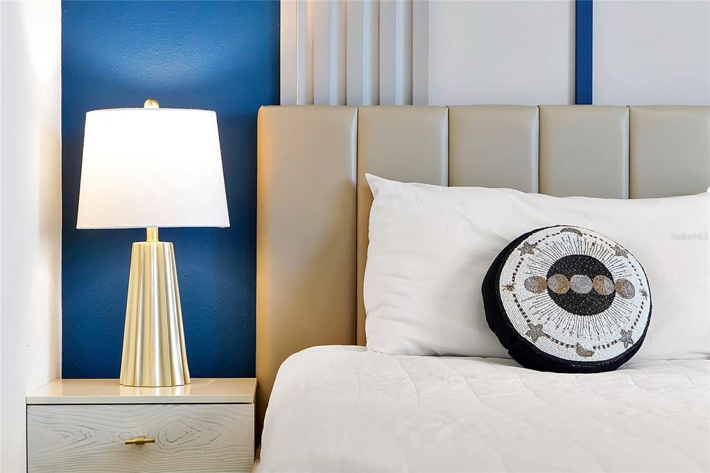 4494 Kaipo Road Davenport, FL 33897 - Photo 66 of 100 a bed sitting in a bedroom next to a window