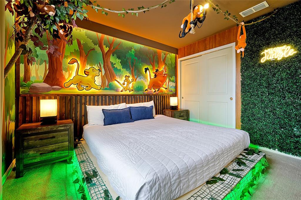 4494 Kaipo Road Davenport, FL 33897 - Photo 70 of 100 a bedroom with a bed and a painting on the wall