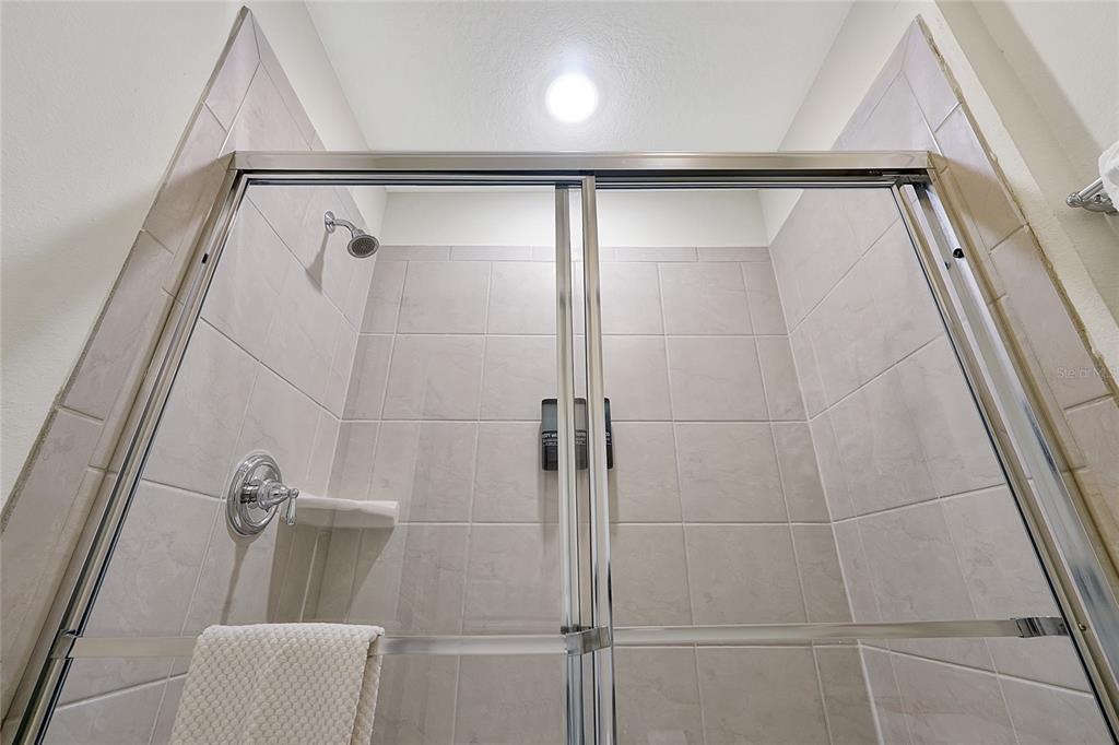 4494 Kaipo Road Davenport, FL 33897 - Photo 79 of 100 a bathroom with a shower and a tub