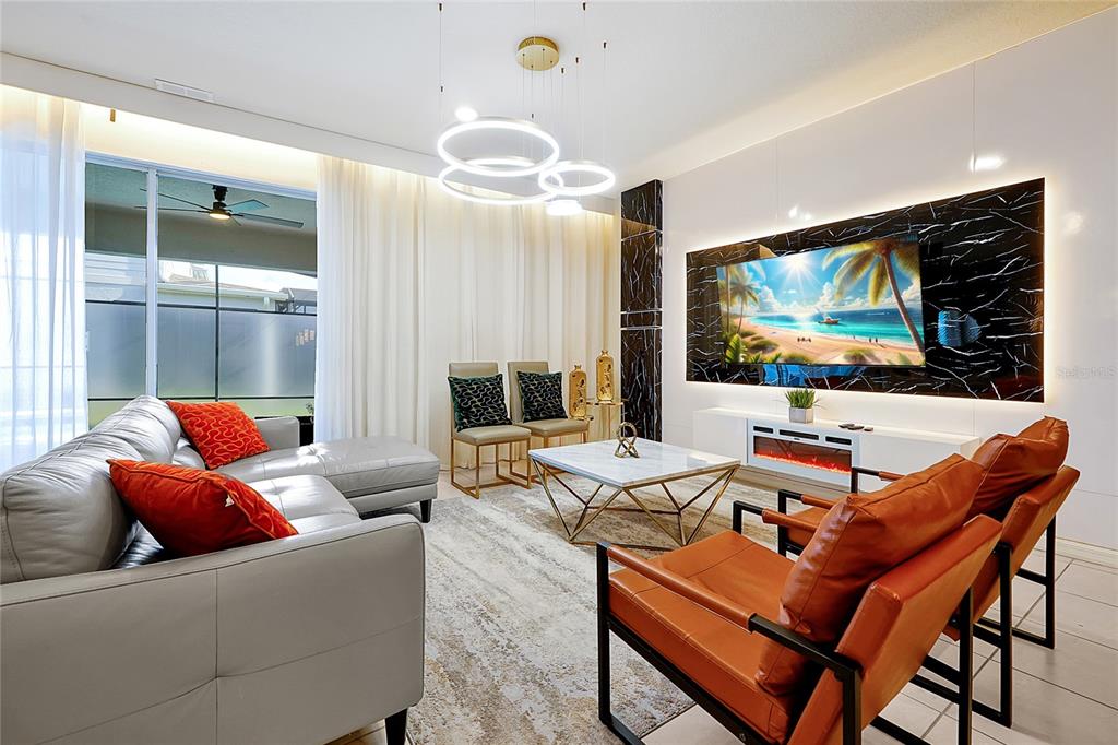 4494 Kaipo Road Davenport, FL 33897 - Photo 8 of 100 a living room with furniture and a flat screen tv