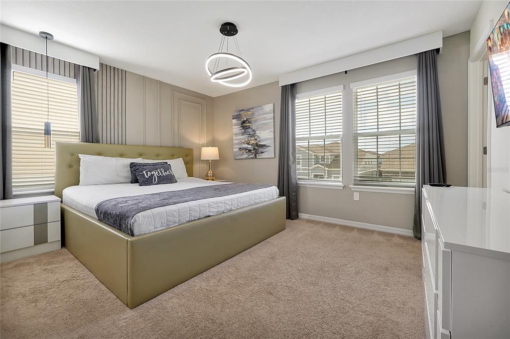 4494 Kaipo Road Davenport, FL 33897 - Photo 84 of 100 a bedroom with a large bed and a large window