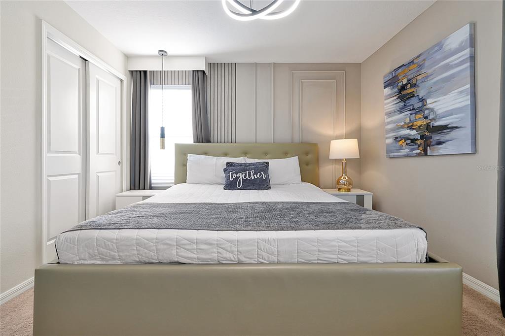 4494 Kaipo Road Davenport, FL 33897 - Photo 85 of 100 a bedroom with a bed and painting on the wall