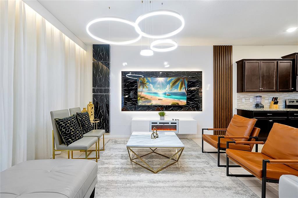 4494 Kaipo Road Davenport, FL 33897 - Photo 9 of 100 a living room with furniture and a flat screen tv