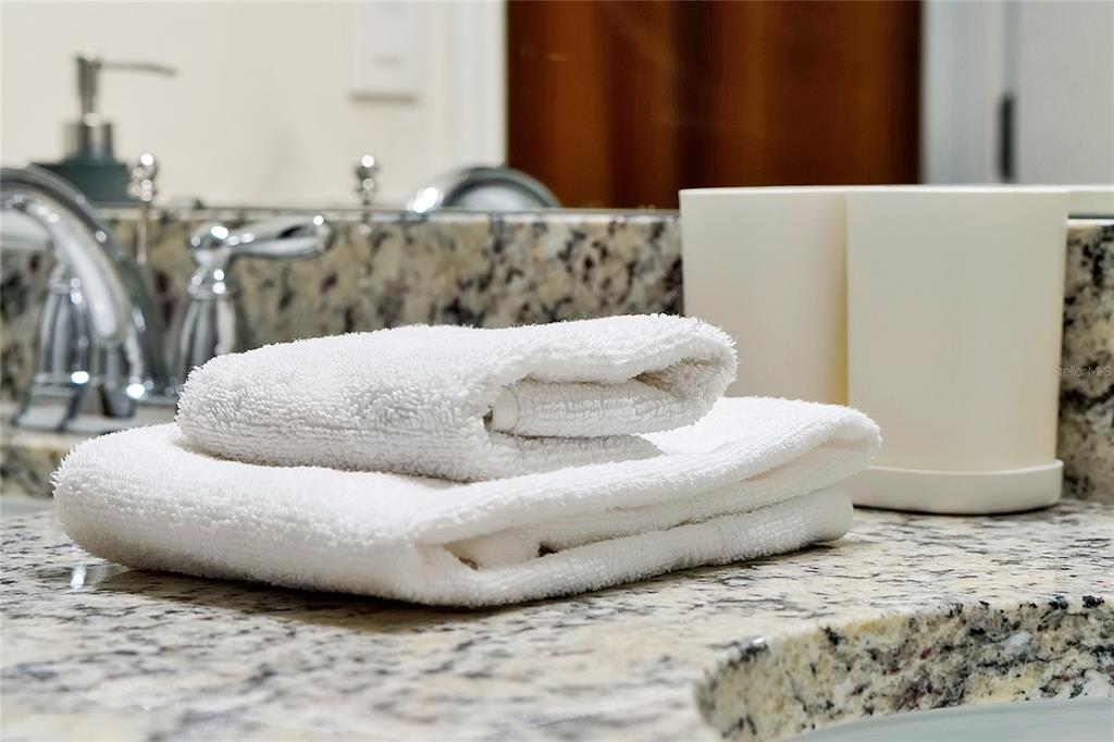 4494 Kaipo Road Davenport, FL 33897 - Photo 95 of 100 a large bed sitting in a bedroom next to a lamp