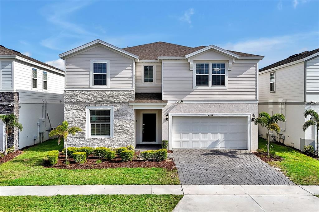 4494 Kaipo Road Davenport, FL 33897 - Photo 100 of 100 a front view of a house with a yard and garage
