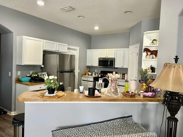 a kitchen with a sink and refrigerator