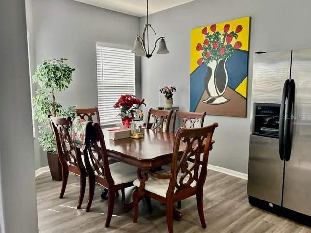 a view of a dining room with furniture and wooden floor