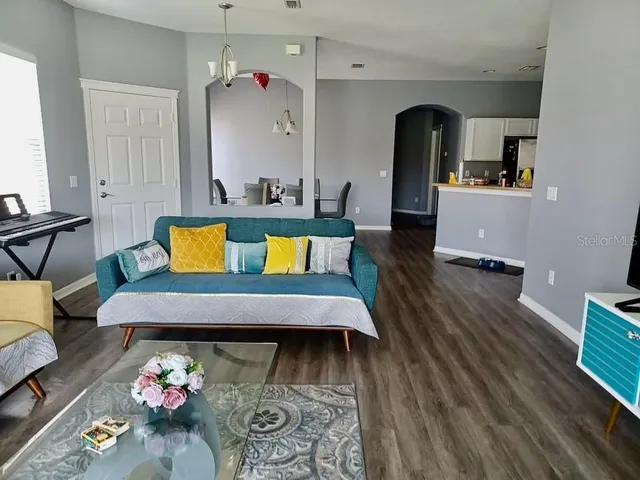 a living room with furniture and wooden floor