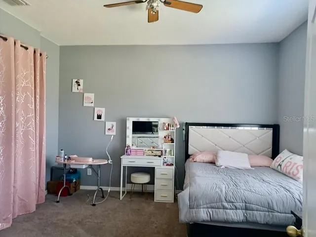 a bedroom with a bed and a table