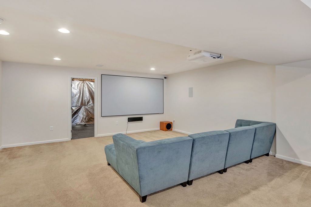 252 Ridgemont Road Ruckersville, VA 22968 - Photo 36 of 48 a living room with furniture and a projector screen
