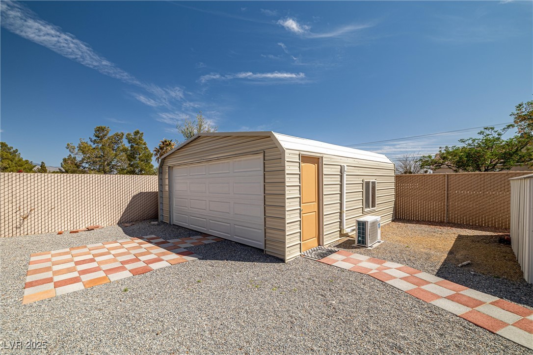 81 Diamond Bar Road Pahrump, NV 89048 - Photo 35 of 38 Detached garage with cooling unit and fence