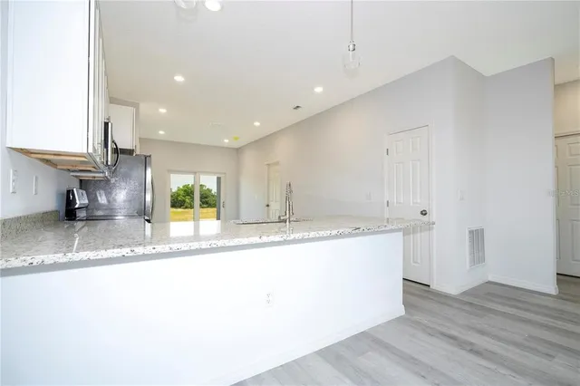 a kitchen with stainless steel appliances granite countertop a sink and a granite counter tops