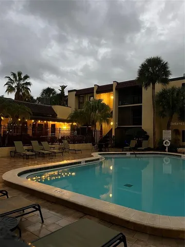 a view of a swimming pool and lounge chairs