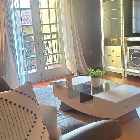 a living room with furniture and a potted plant