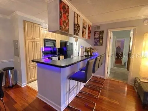 a kitchen view with granite countertop a stove and a refrigerator
