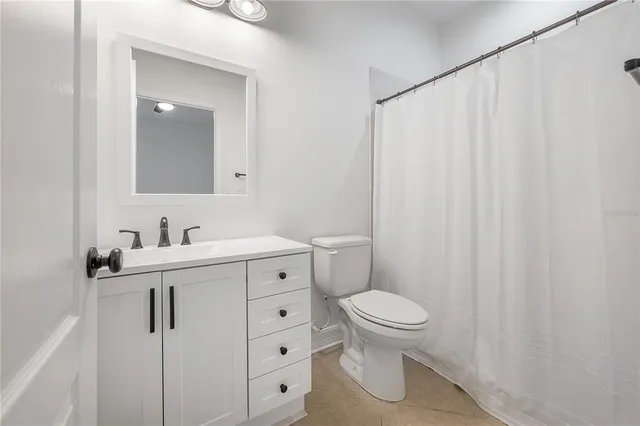 a bathroom with a sink a toilet and vanity