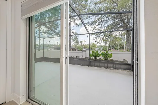 a view of a glass door with a yard from a window