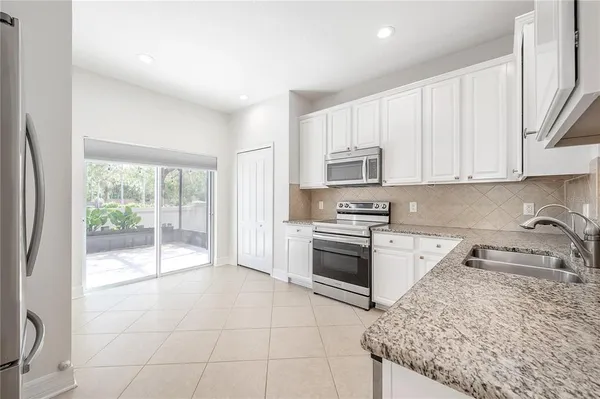 a kitchen with a stove a sink and a refrigerator