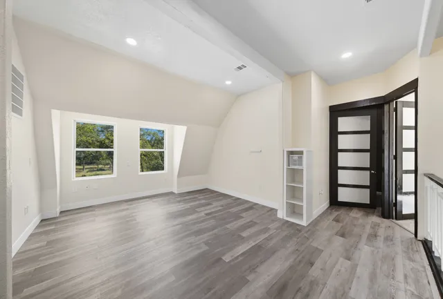 a bedroom with a bed and a mirror