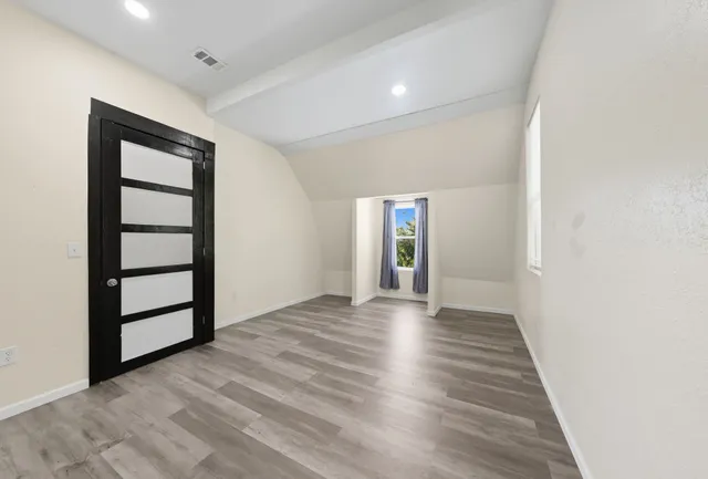 a bathroom with a tub a sink and a window