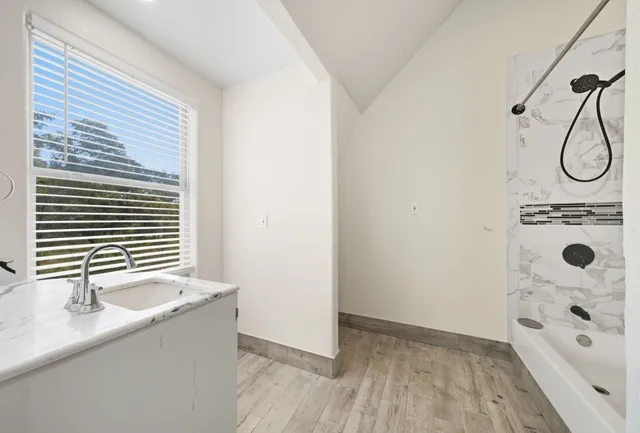 a bathroom with a tub and a shower