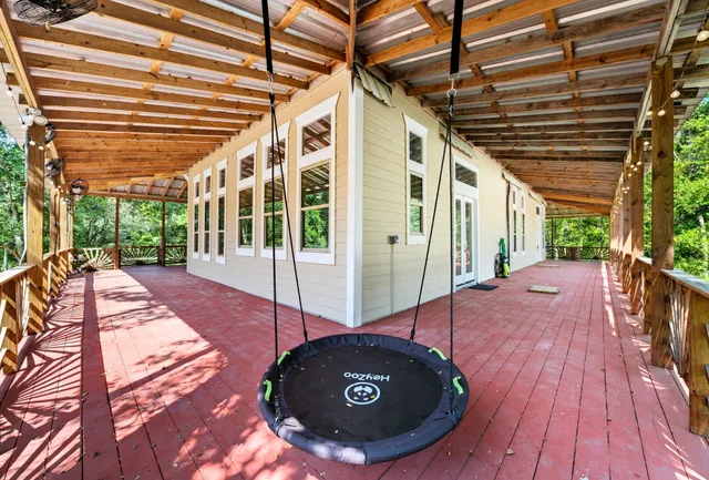 a view of a porch with wooden floor