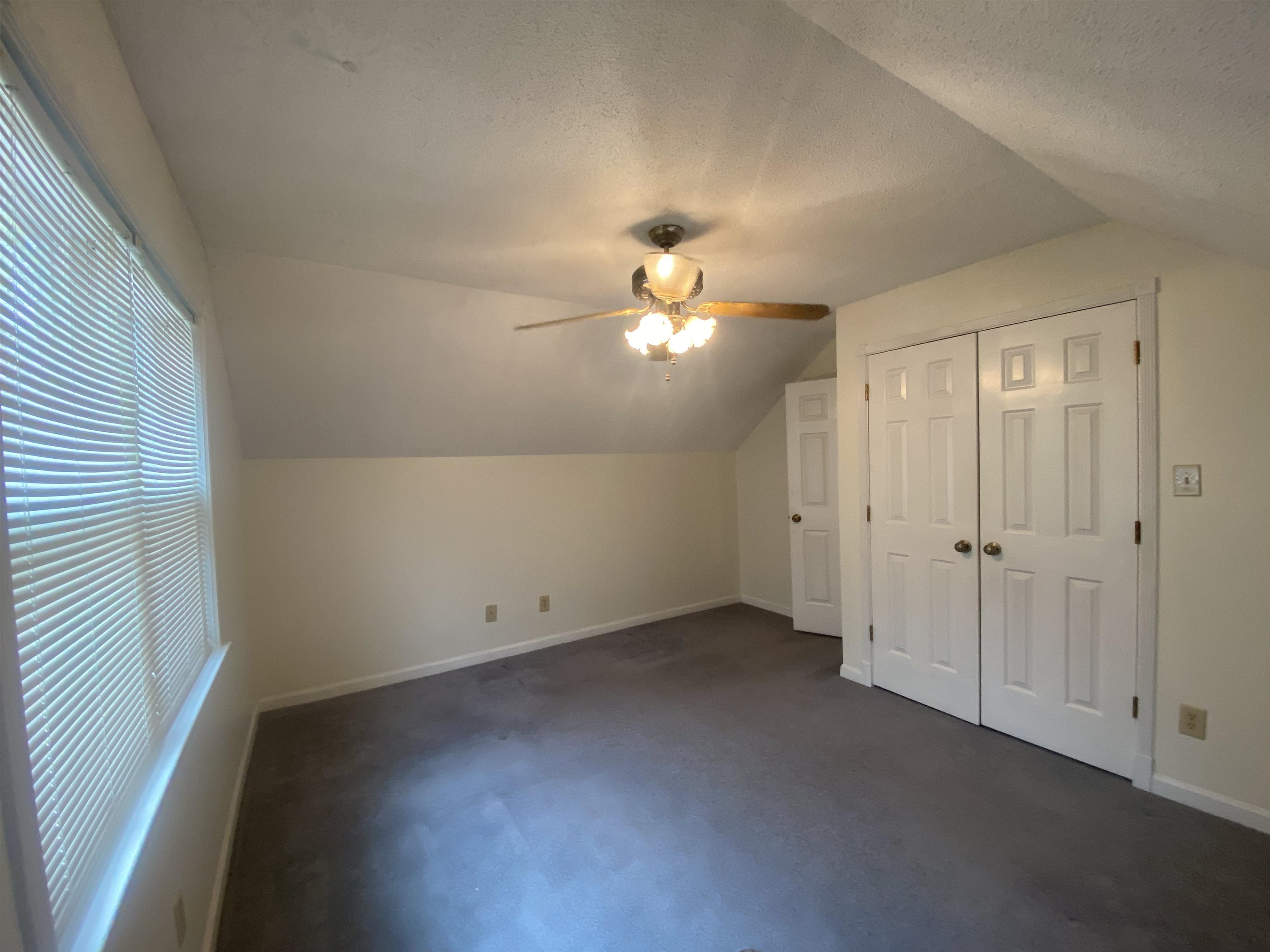 339 Dove Valley Road Collierville, TN 38017 - Photo 13 of 20 an empty room with a chandelier fan and windows