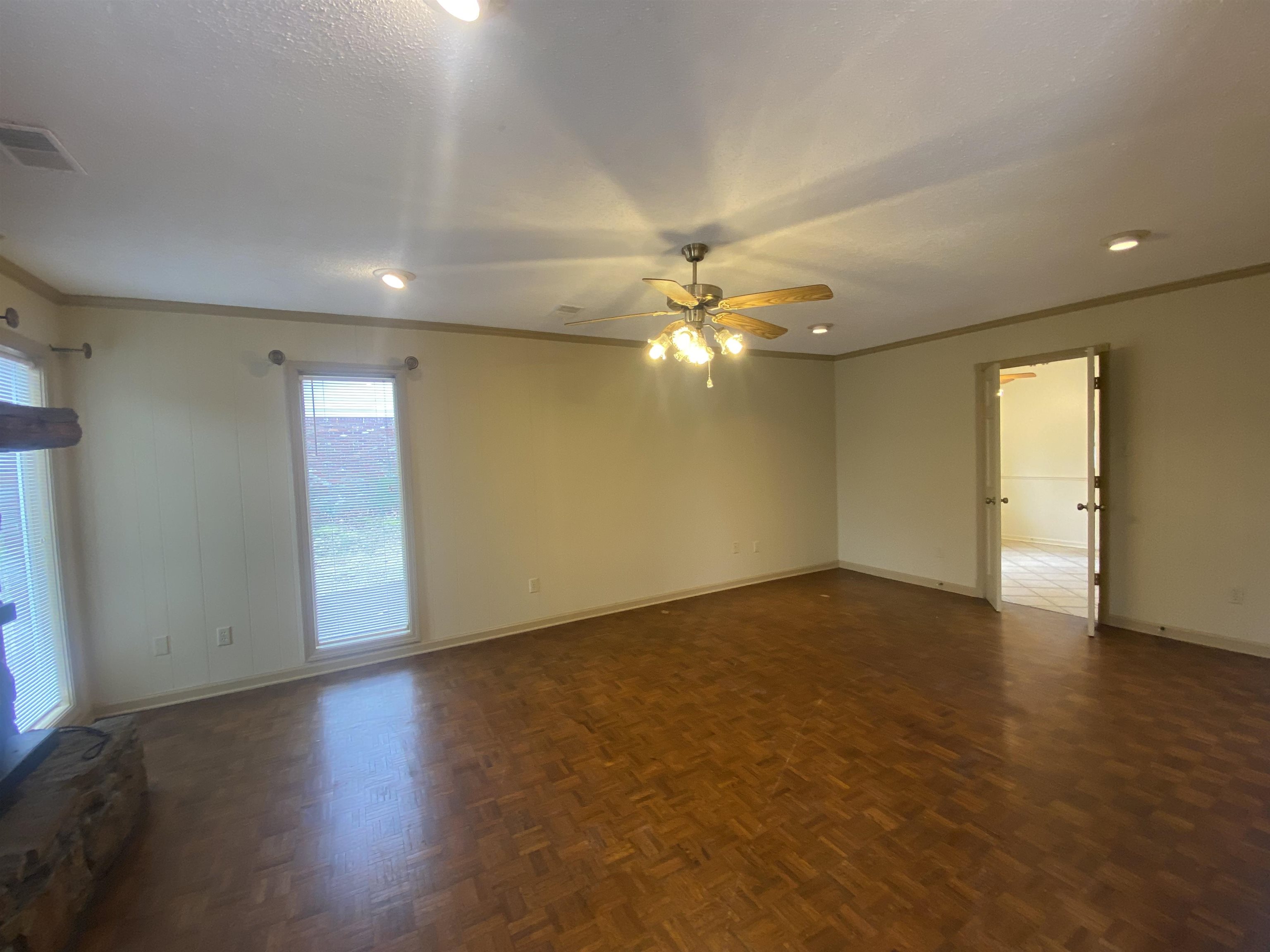 339 Dove Valley Road Collierville, TN 38017 - Photo 3 of 20 an empty room with wooden floor and chandelier fan