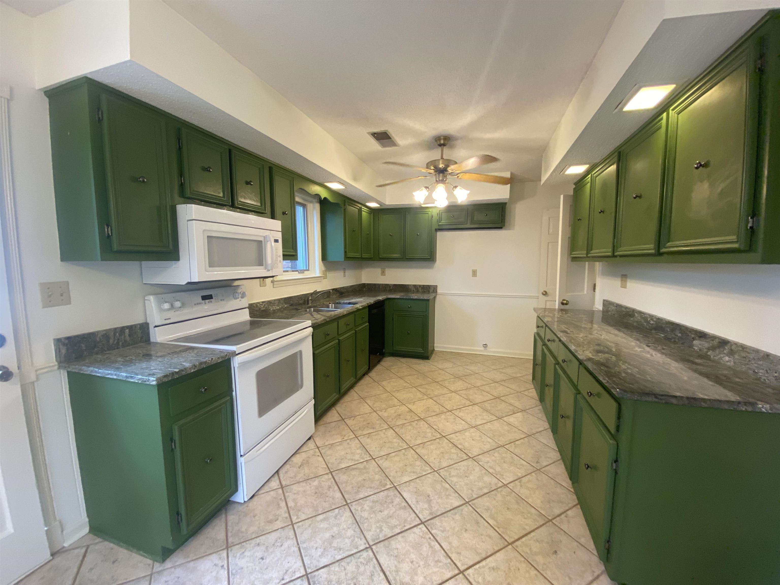 339 Dove Valley Road Collierville, TN 38017 - Photo 5 of 20 a kitchen with a sink and a stove top oven