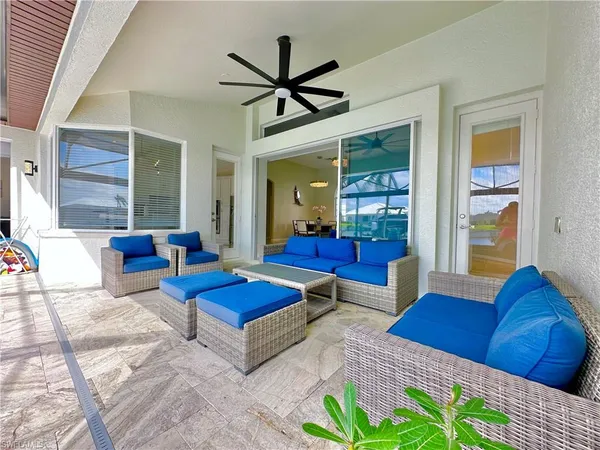 a living room with furniture a rug and a large window