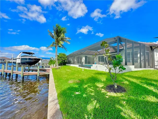 a front view of house with yard and swimming pool
