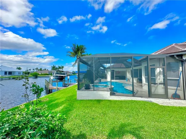 a view of a house with a big yard and potted plants
