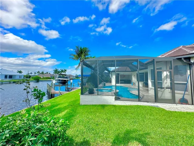 a view of a house with a big yard and potted plants