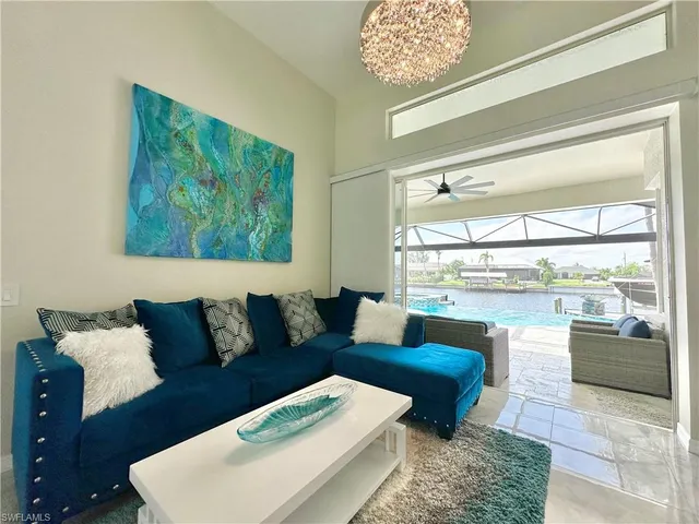 a living room with furniture a rug and white walls