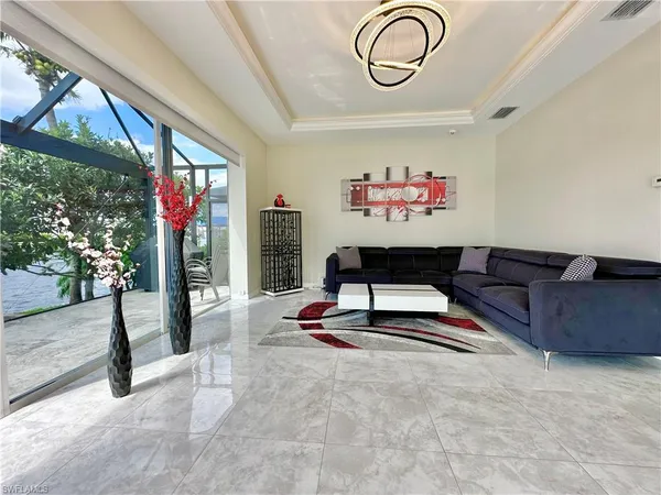 a living room with furniture a window and a potted plant