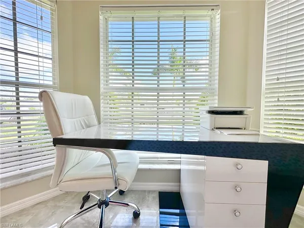 a kitchen with white cabinets and appliances