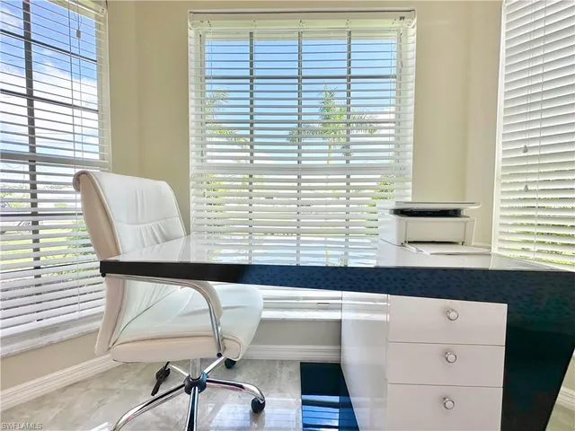 a kitchen with white cabinets and appliances