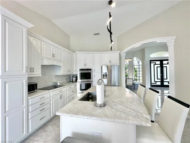 a kitchen with cabinets and wooden floor