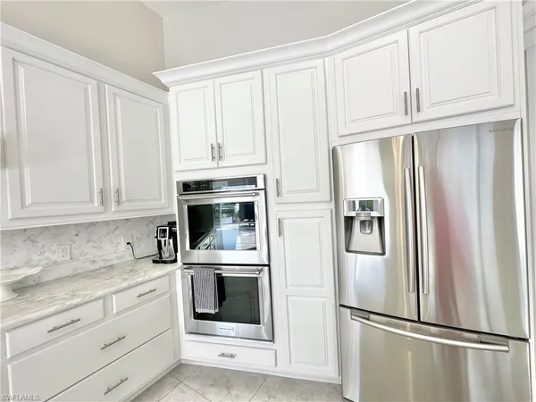 a kitchen with granite countertop a sink and dishwasher with wooden floor