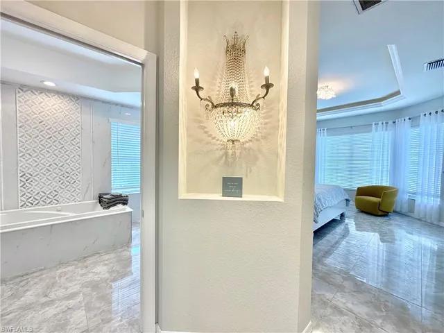 a bedroom with a bed and large windows