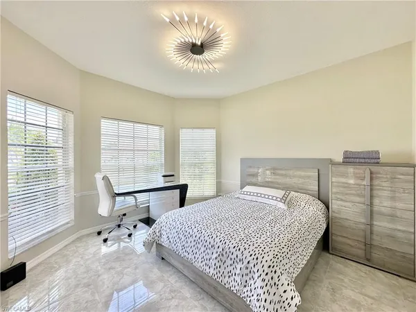a spacious bathroom with a double vanity sink mirror and bathtub