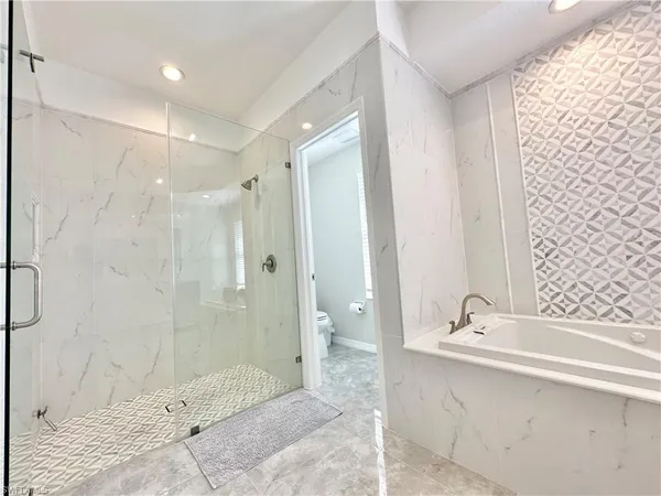 a bathroom with a bathtub and shower
