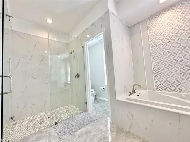 a bathroom with a bathtub and shower