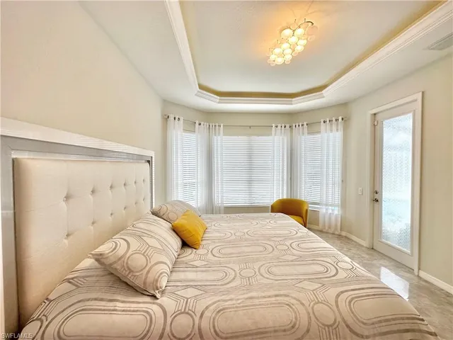 a bedroom with a bed and painting on the wall