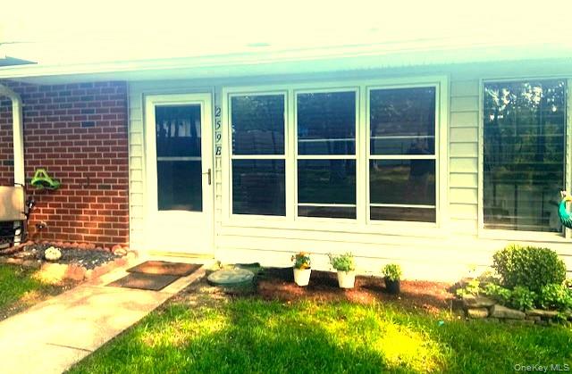 Property entrance featuring brick siding