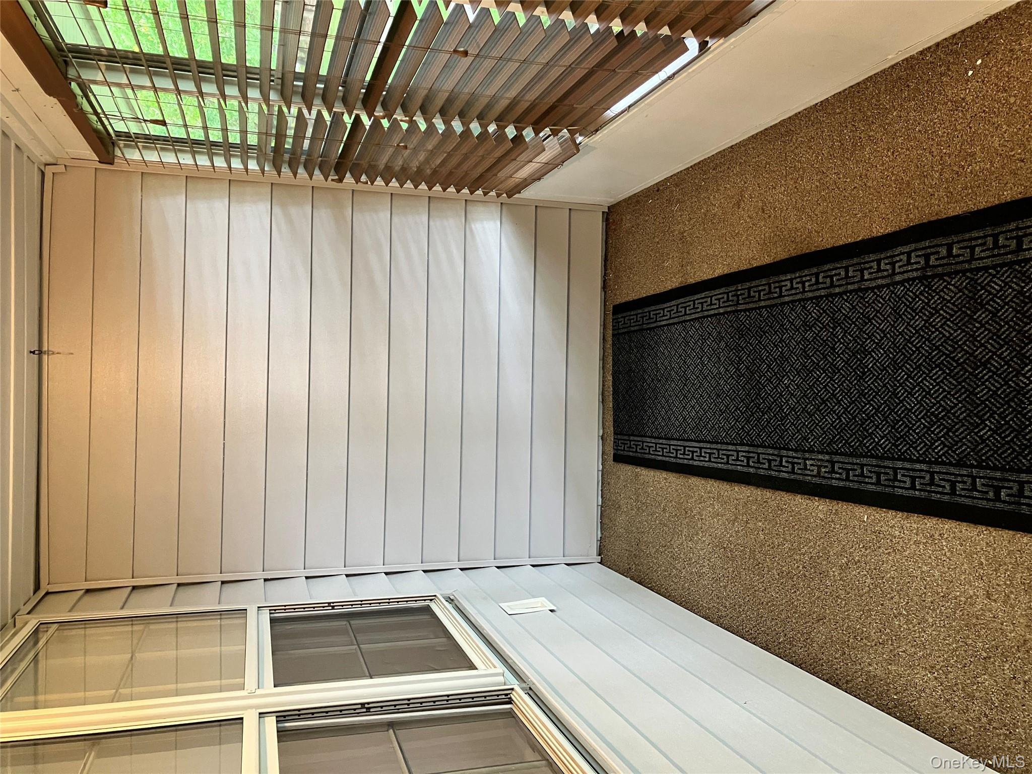 259 Newcastle Court, Unit E Ridge, NY 11961 - Photo 4 of 20 View of unfurnished sunroom