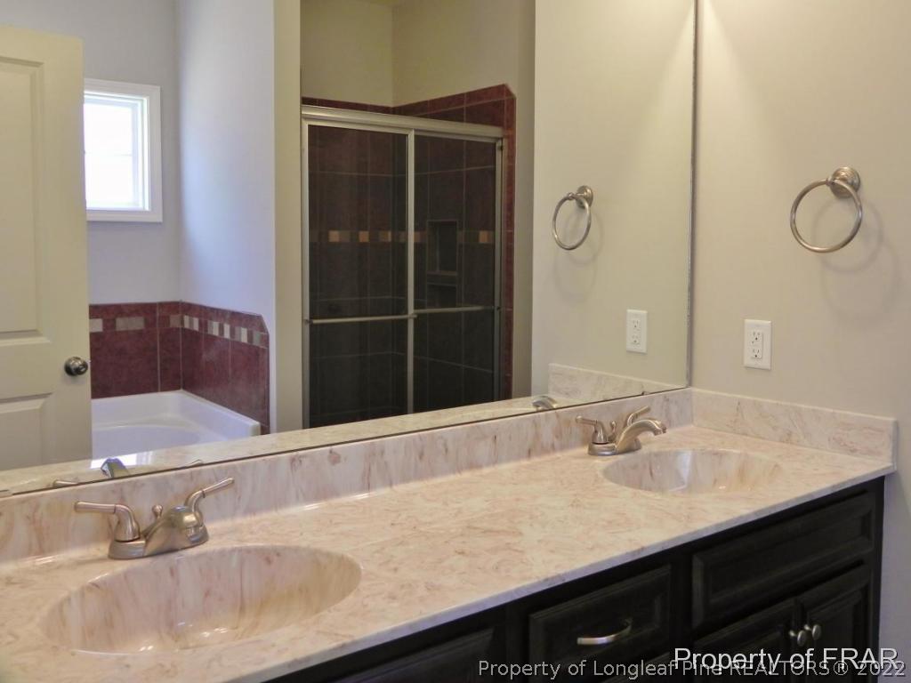 1280 Rays Bridge Road Whispering Pines, NC 28327 - Photo 11 of 22 a bathroom with a sink and a mirror